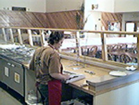 Boxing the finished pizza for delivery