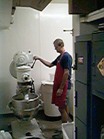 Mixing pizza dough ingredients in a large bowl